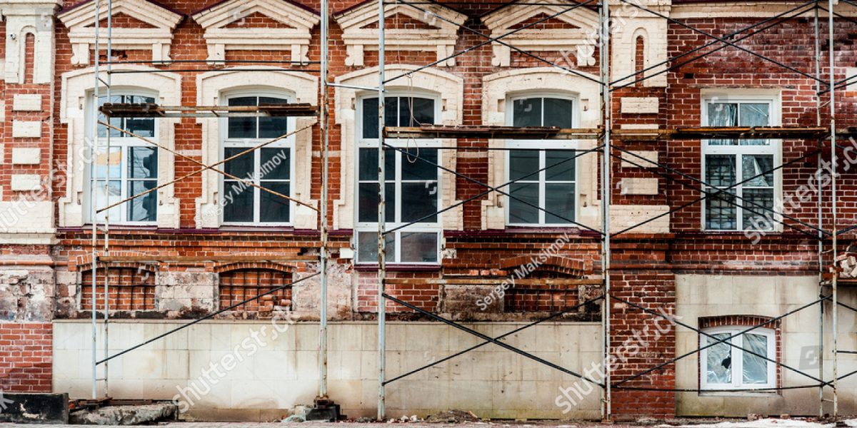 stock-photo-restoration-of-old-building-with-white-windows-and-red-blocks-374935243